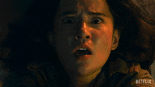 a close up of a woman 's face with the word netflix on the bottom right