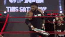 a wrestler in a black shirt that says hot dog on it