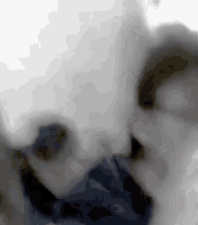 a blurry picture of a person wearing a mask .