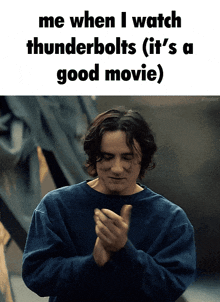 a man in a blue shirt is clapping his hands in front of a white background that says me when i watch thunderbolts