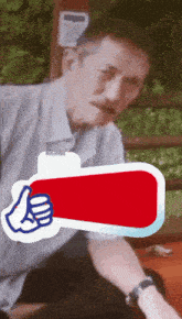 a man with a mustache is giving a thumbs up