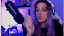 a girl with purple hair is wearing headphones and a microphone that says map