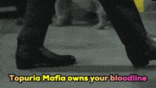 a man 's feet are shown with the words topuria mafia owns your bloodline