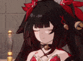 a girl with black hair and red ribbons on her head is sitting with her eyes closed