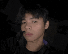 a young man wearing headphones with a microphone attached to it