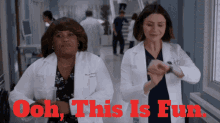two female doctors are dancing in a hallway with the words " ooh this is fun " in red