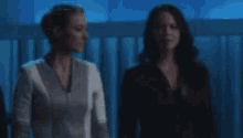 two women are standing next to each other and the words well this is a little awkward are visible