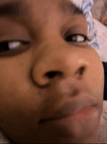 a close up of a person 's face with a serious look on their face