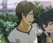 a boy and a girl are standing next to each other and the girl is holding the boy 's arm