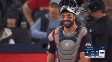 a man in a catcher 's uniform is smiling in front of a sign that says williams