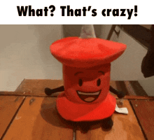 a stuffed animal is sitting on a wooden table .