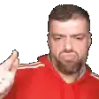 a man with a beard wearing a red hoodie is giving a thumbs up sign .
