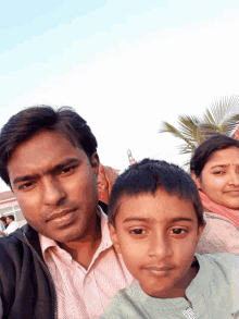 a man and a boy are posing for a picture