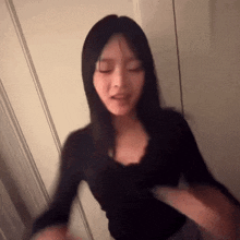 a blurry picture of a woman in a black shirt dancing