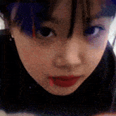 a close up of a woman 's face with a red lip