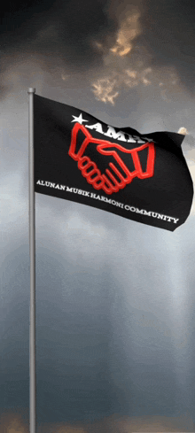 a black flag with a red handshake on it that says alumni musik harmoni community