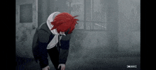 a person with red hair is kneeling down in a dark room