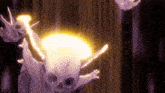 a cartoon character with a skull on his head is flying through the air with a yellow light coming out of his mouth .