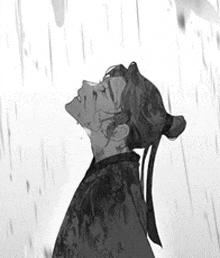 a man in a kimono is standing in the rain looking up at the sky .