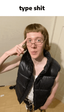 a man wearing glasses and a black vest is pointing his finger at his head with the words type shit below him