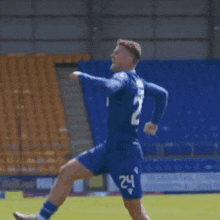 a soccer player with the number 24 on his shorts is running