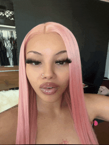 a woman with pink hair has a nose ring