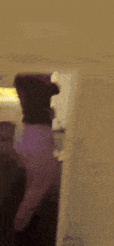 a blurred image of a person standing in a room