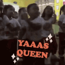 a group of people are standing in front of a sign that says " yaaas queen "
