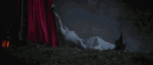a woman in a white dress is laying down in the grass