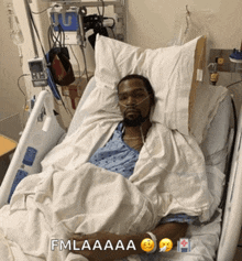a man is laying in a hospital bed with the words fmlaaaa on the bottom right
