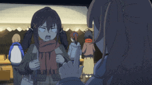a girl with pigtails is wearing a scarf and making a funny face