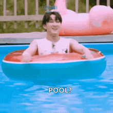 a man is floating in an inflatable raft in a swimming pool and asking , `` pool ? ''