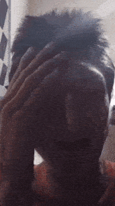 a close up of a person 's face with a hand on their forehead