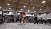 two women in a wrestling ring with a banner that says kennedy on it