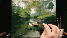 a hand is holding a brush in front of a painting that says made in animonica