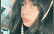 a close up of a girl 's face in front of a fan
