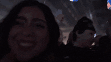 a woman taking a picture with a cell phone in a crowd of people with the word shagarita on the bottom