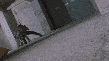 a person riding a motorcycle in a hallway with a reflection of a person in a mirror