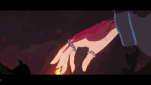 a close up of a person 's hand in a dark room with red lights .