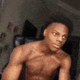a shirtless young man is sitting in a chair .