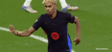 two soccer players on a field with the word espana on the bottom left