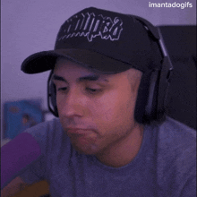 a man wearing headphones and a hat that says ' imantasdogs ' on it