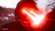 a close up of a person 's face with a red light coming out of it