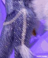 a close up of a person 's leg with a purple background