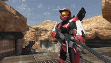 a man in a red helmet holding a gun