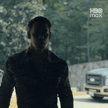 a silhouette of a man standing in front of a hbo max logo