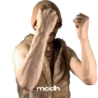 a man wearing a fur vest and a beanie has the word mcdh on the bottom