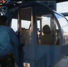 a blue vehicle with the number 6 on the side