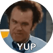 a man in a blue shirt and tie is in a circle with the word yup written on it .