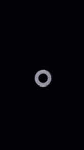 a black background with a white flower in the center